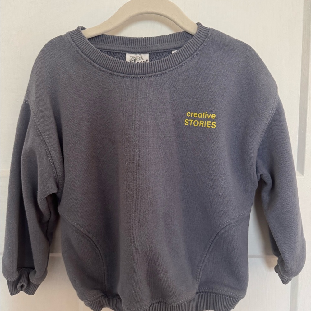 Zara Kids gray sweatshirt with yellow "creative STORIES" logo